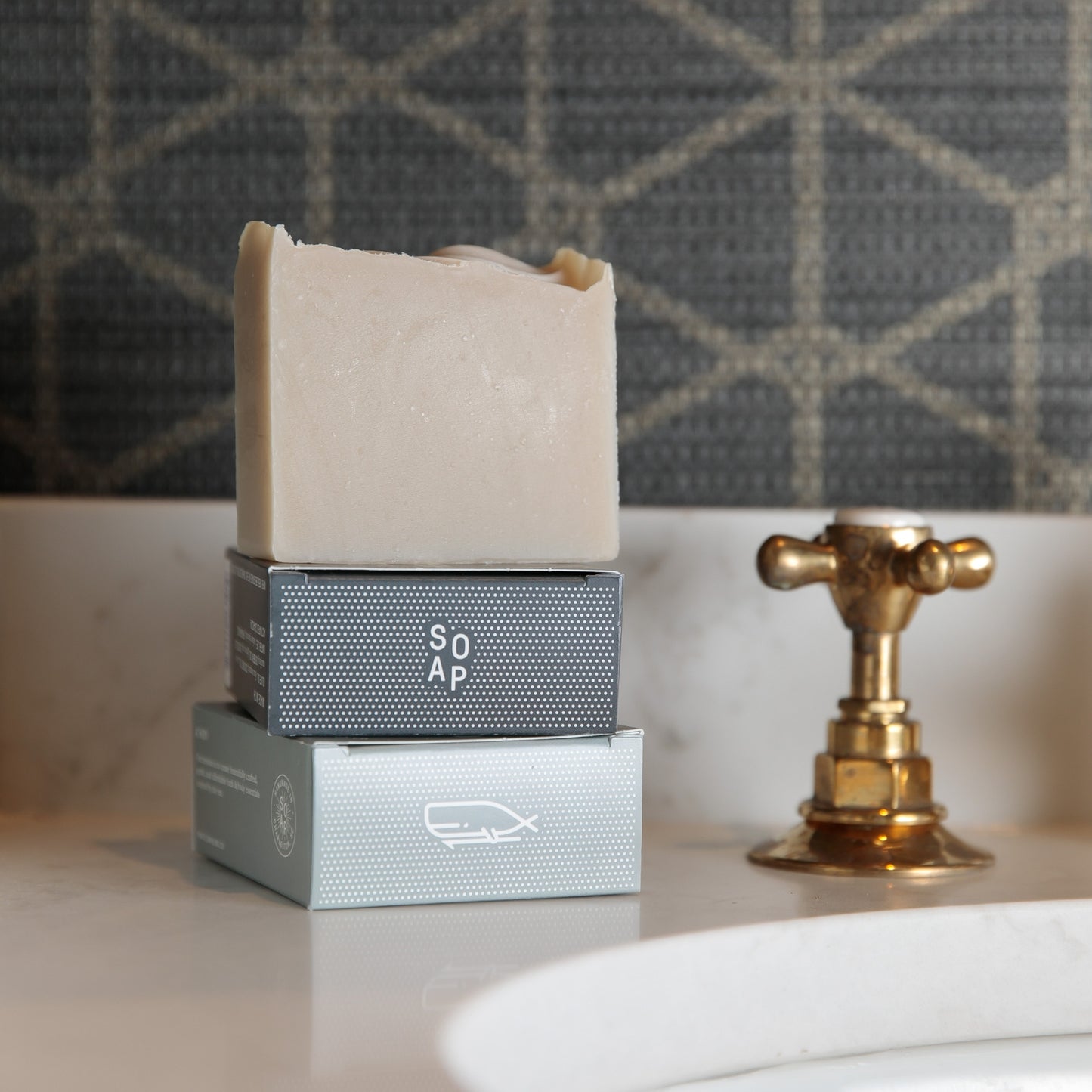 Bamboo & Teak Bar Soap sitting on top of Old Whaling Co Bar Soap boxes beside sink
