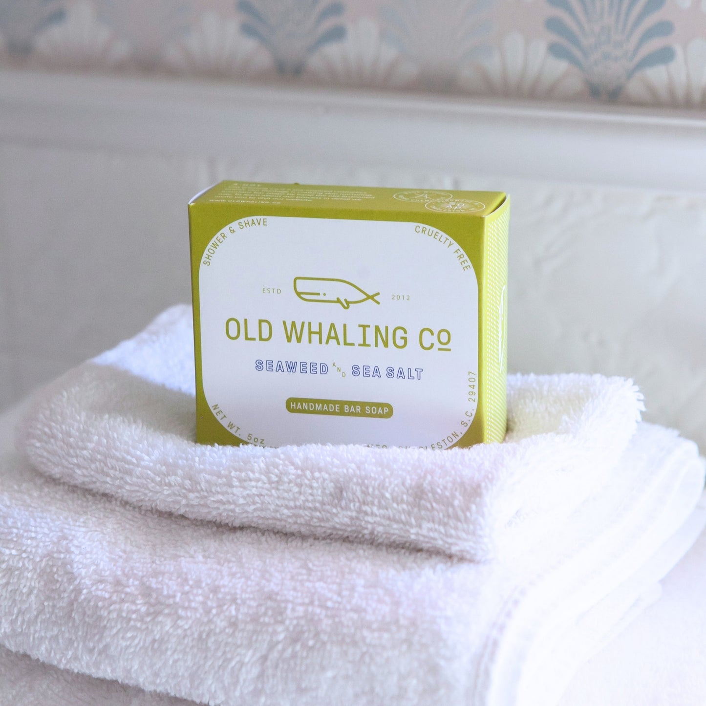 Seaweed & Sea Salt Bar Soap box sits on stack of white towels