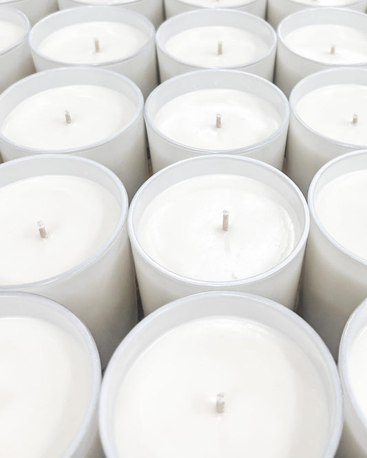 Old Whaling Co. soy and olive wax candles organized on table with trimmed wicks and cooling wax