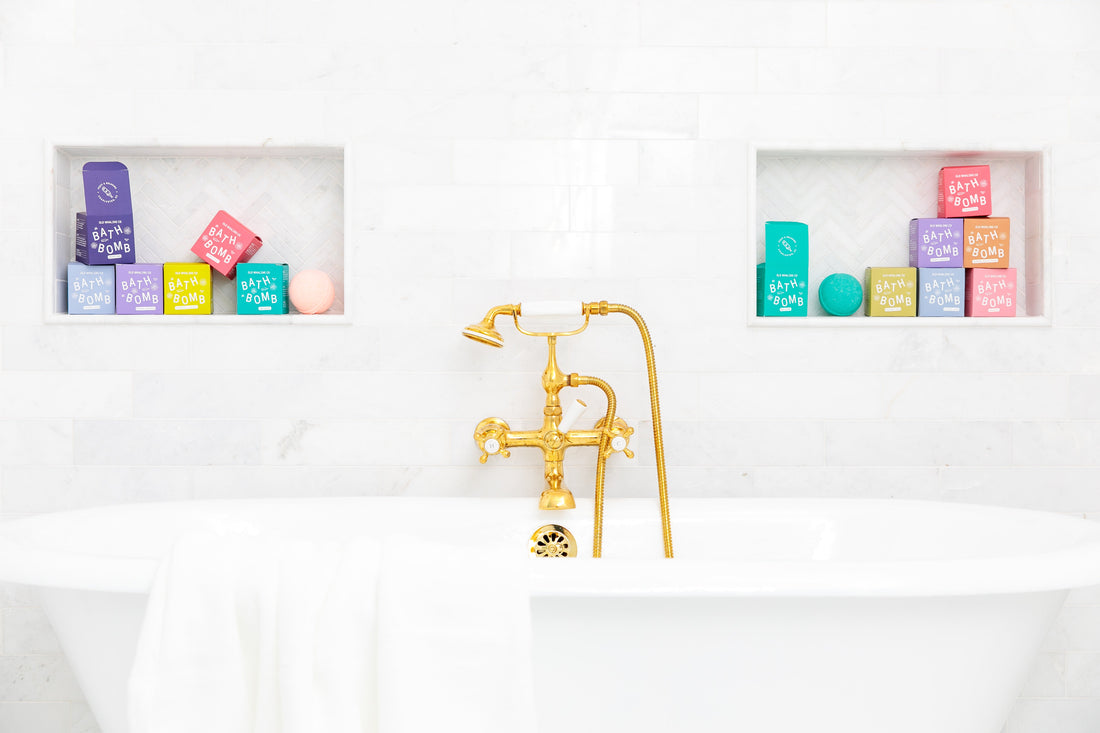 Bath tub with Old Whaling Co bath bombs on shelves in background