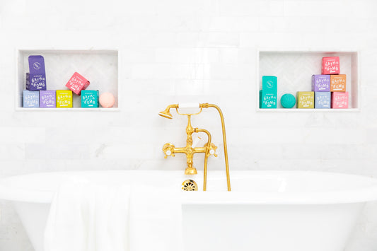 Bath tub with Old Whaling Co bath bombs on shelves in background