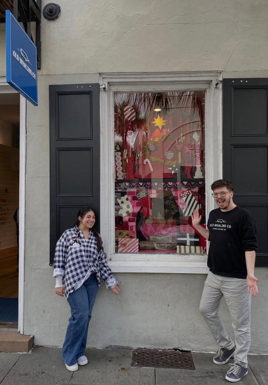 Hunter and Bekah posing in front of winning holiday display windows