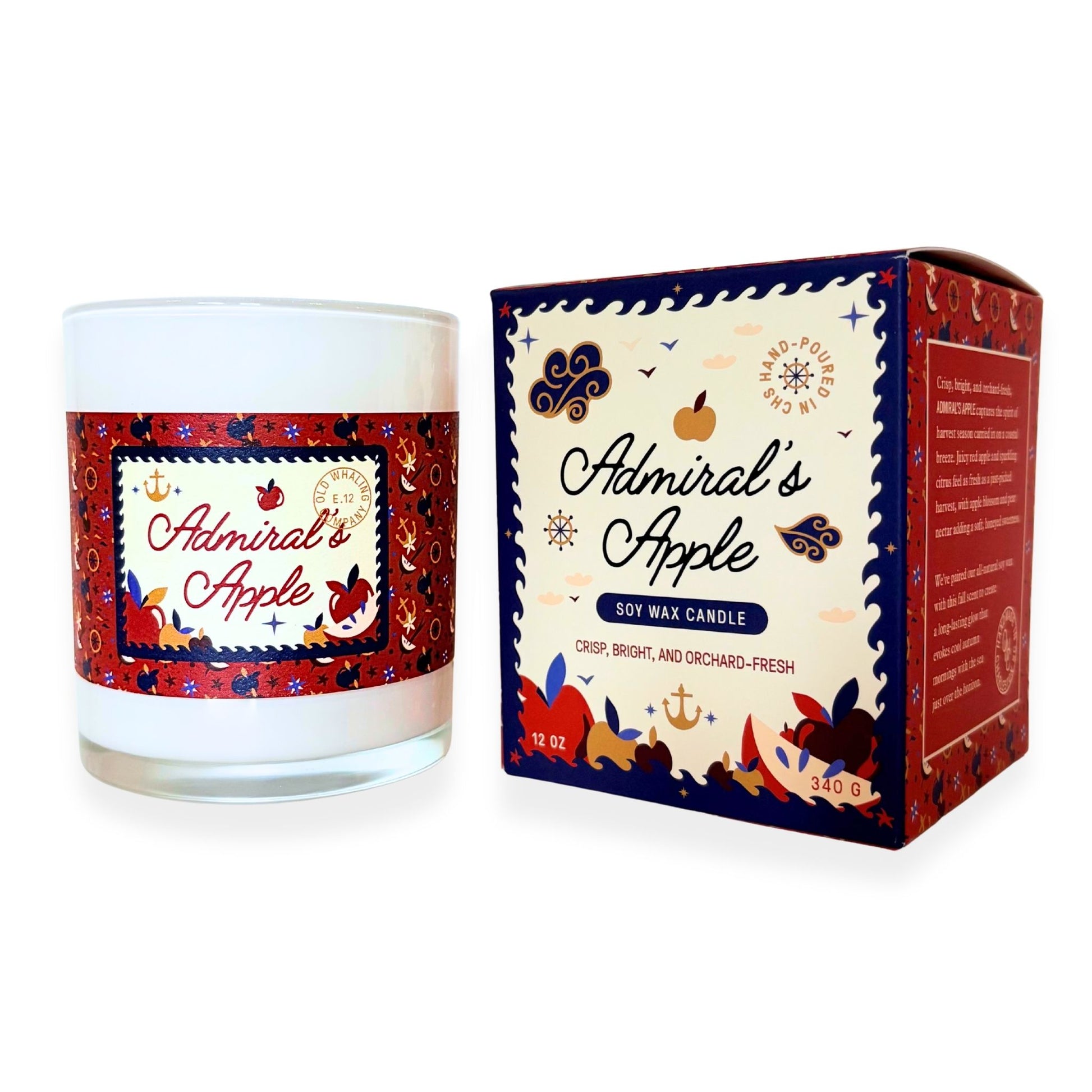 A soy wax candle in a clear glass jar with a white wax fill and a decorative red, navy, and cream label reading 'Admiral's Apple,' shown next to its matching product box on a white background.