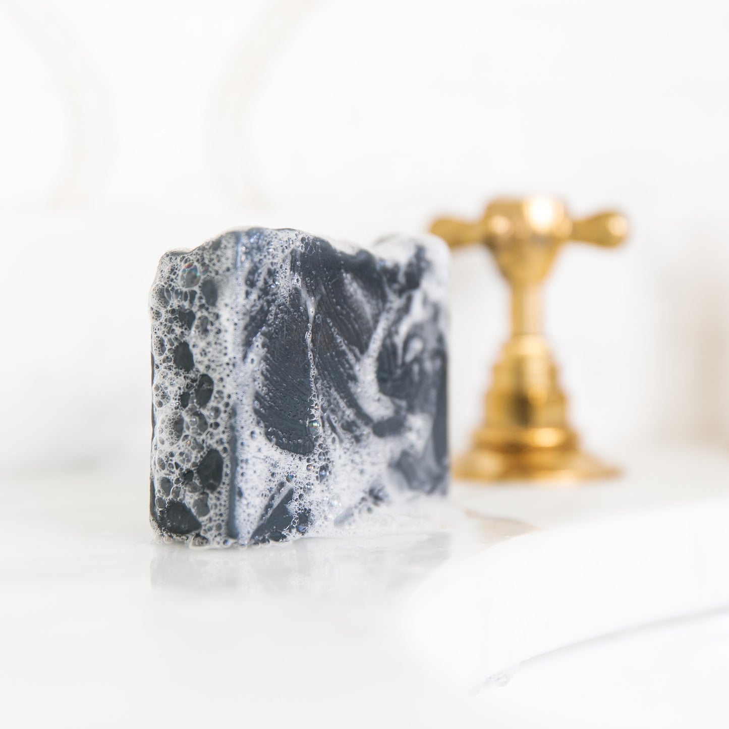 Bergamot & Grapefruit with suds sitting beside sink