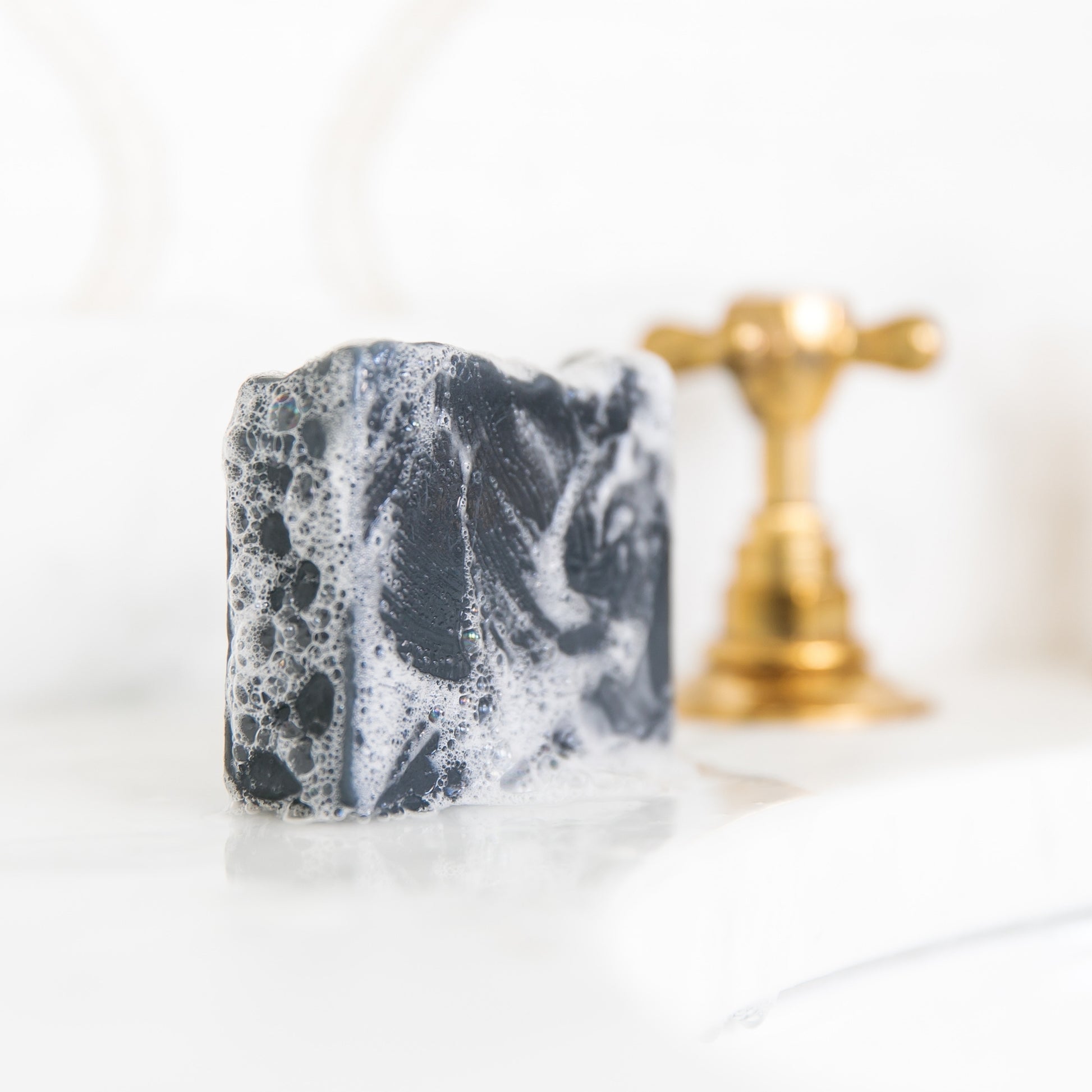 Bergamot & Grapefruit with suds sitting beside sink