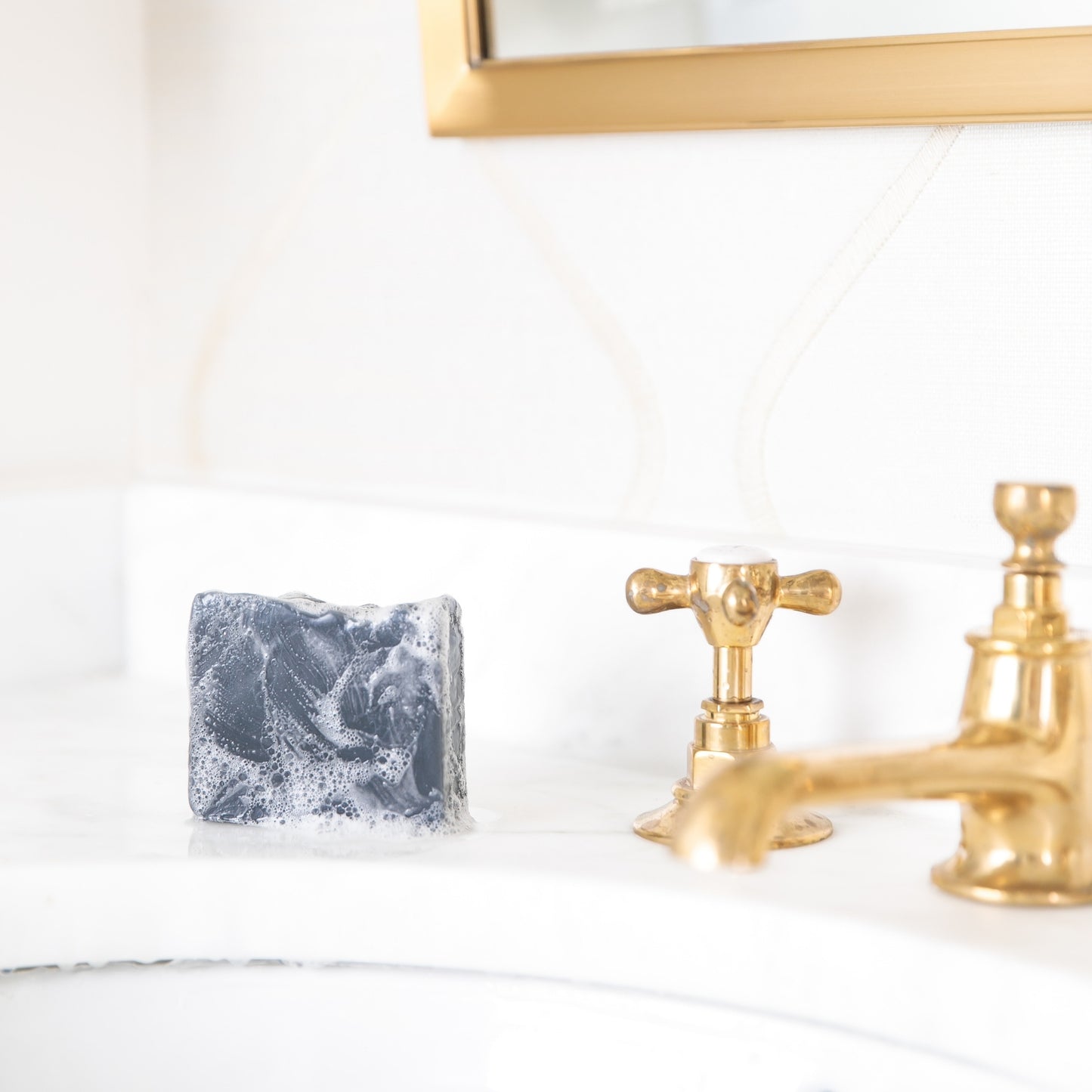 Bergamot & Grapefruit with suds sitting beside sink