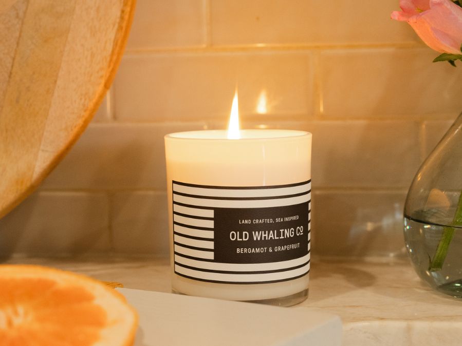 Old Whaling Company Bergamot & Grapefruit candle lit on kitchen counter by sink