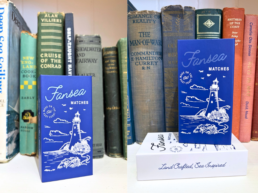 Blue matchbox with lighthouse design among vintage books