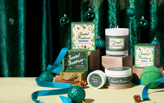 Decorative Christmas items including candles, bath products and ornaments on a green textured background.