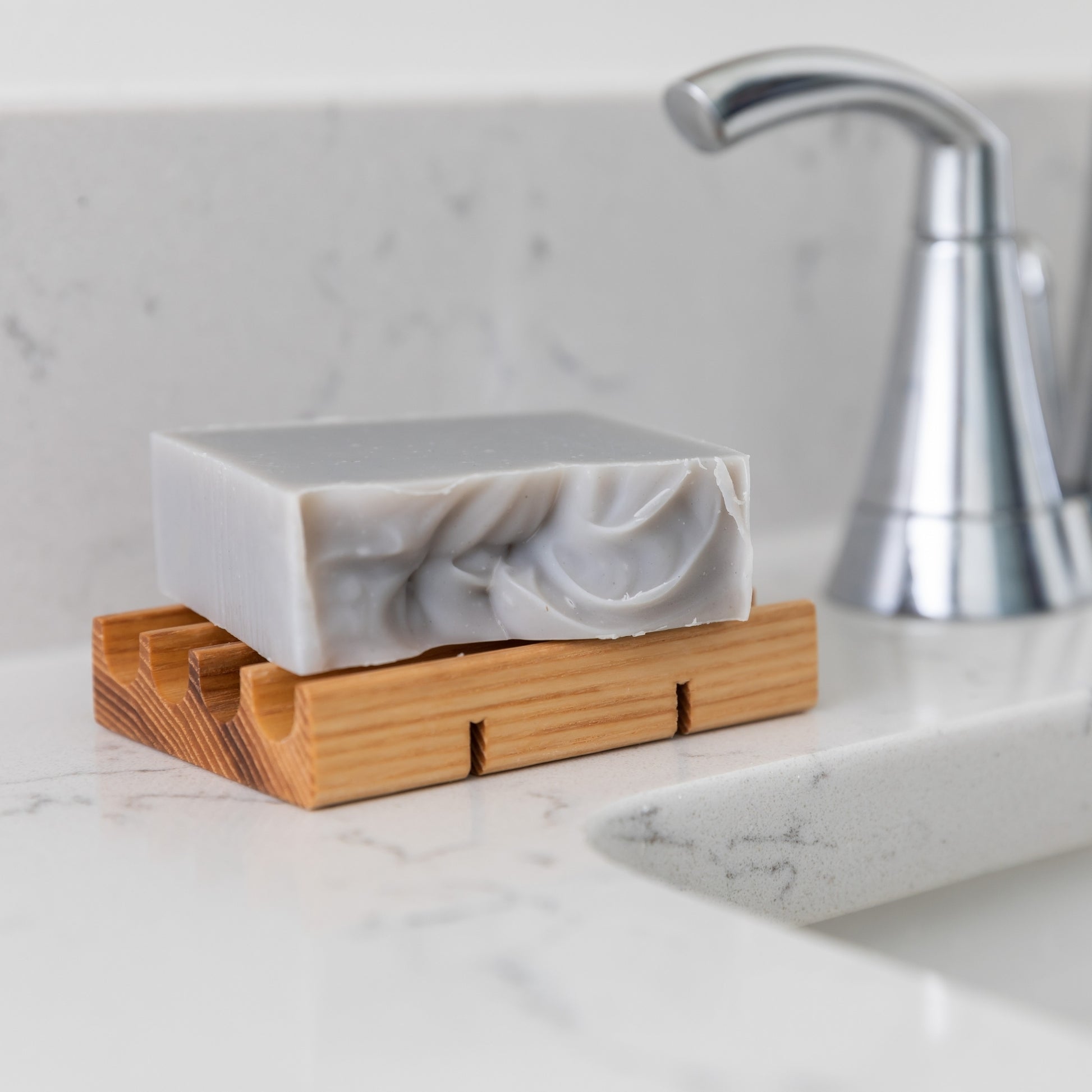 Coastal Calm Bar Soap laying flat on Wood Soap Dish