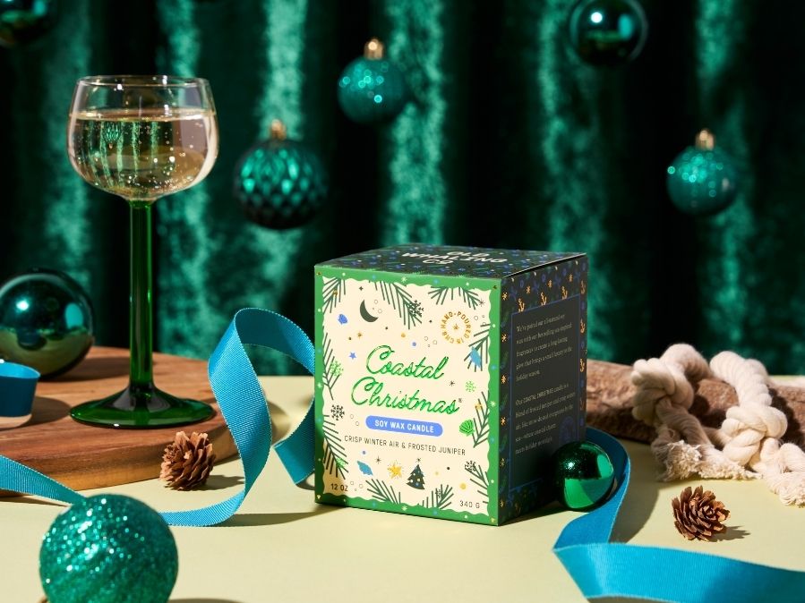 Box of Coastal Christmas candles on a table with festive decorations