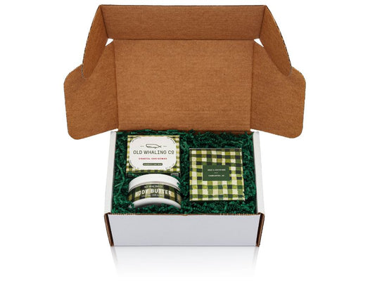 Coastal Christmas gift box with green crinkle in a white box on a white background