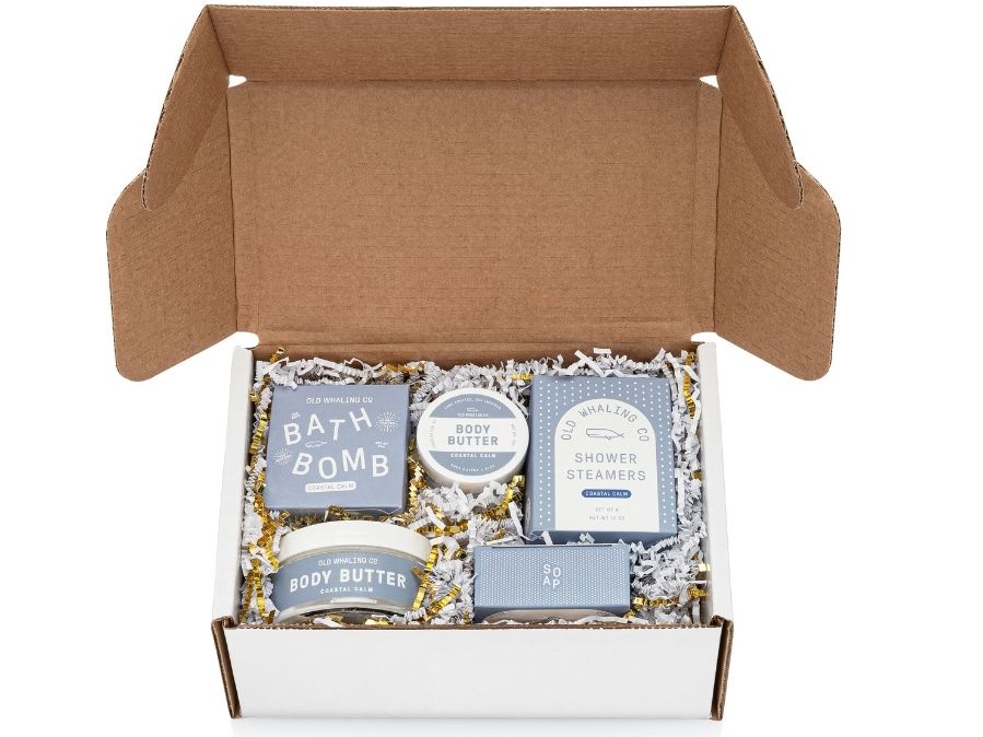 Old Whaling Company white gift box with Coastal Calm® product collection and gold and white crinkle paper