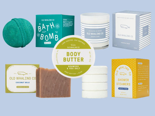Collection of Old Whaling Co. coastal skincare and bath products on a light blue background