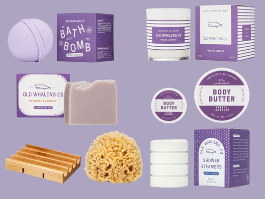 Deluxe collection of lavender Old Whaling Co. bath and body products on a purple background