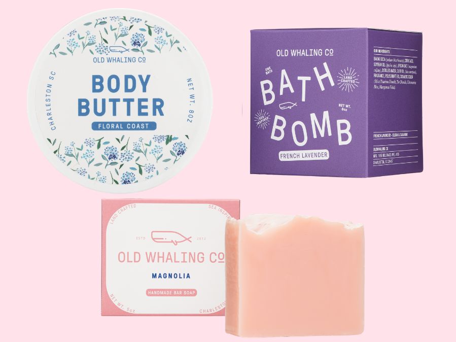 Old Whaling Co floral skincare products including body butter, bath bomb, and soap on a pink background