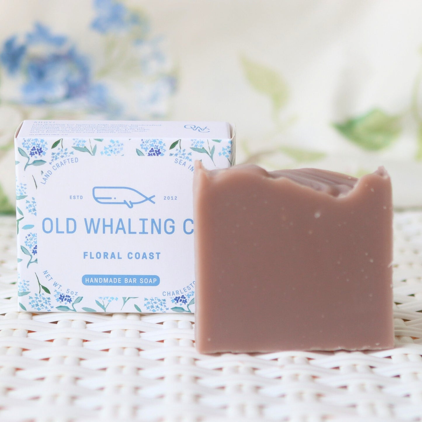 Floral Coast Soap and packaging sitting on woven mat