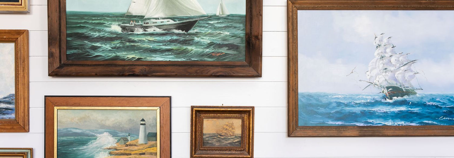 Old Whaling Co King Street Shop wall featuring ship and nautical paintings
