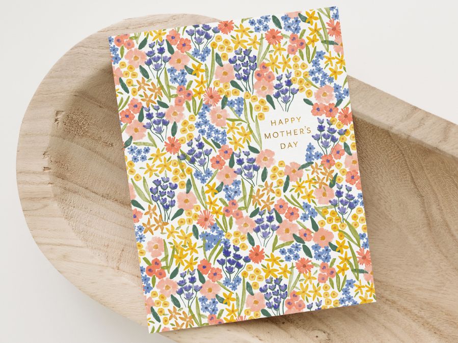 Floral Mother's Day card on a white background and wooden decorative bowl