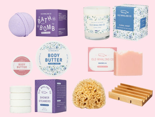 Deluxe collection of floral Old Whaling Co. bath and body products on a pink background