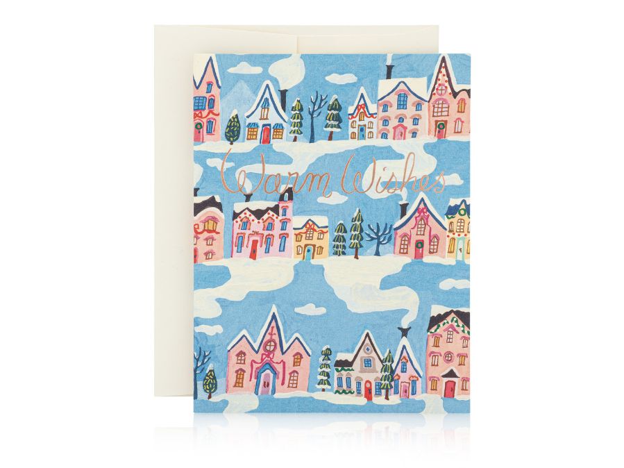 Warm wishes winter greeting card with snow and pastel colored homes 