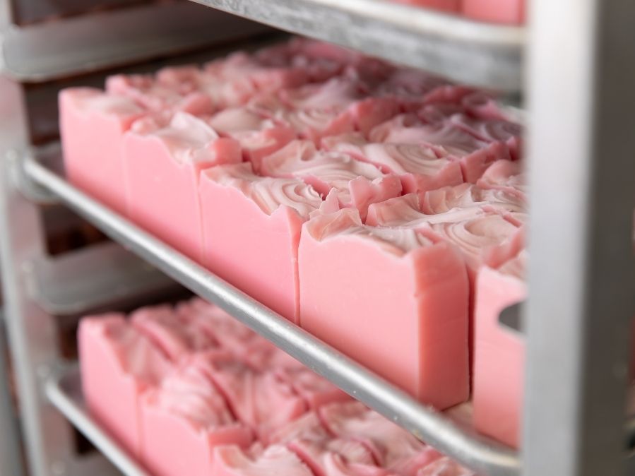 Drying Magnolia soap on metal racks at Old Whaling Company production warehouse in Charleston, SC