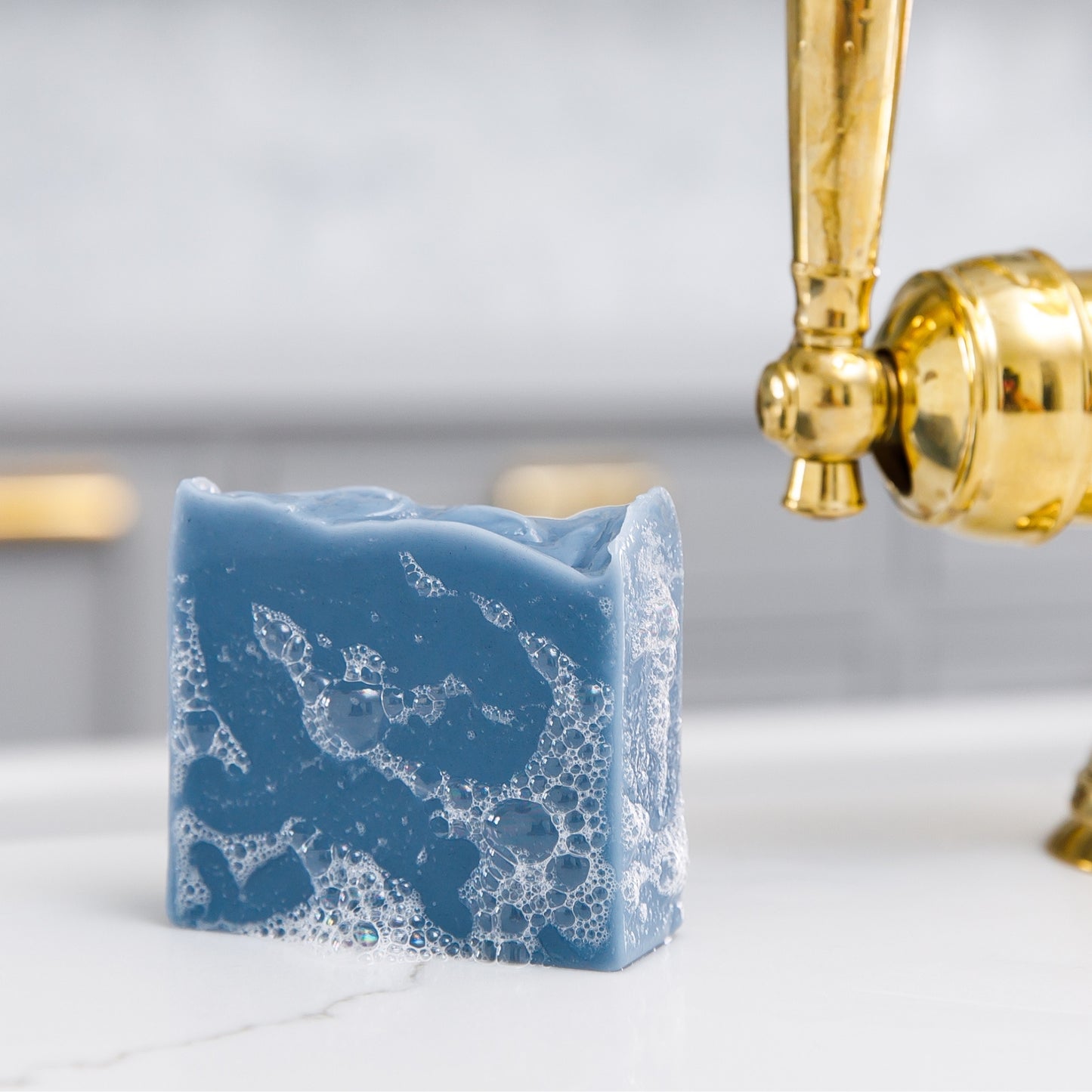 Sudsy Oceanswept Bar Soap sits beside sink 