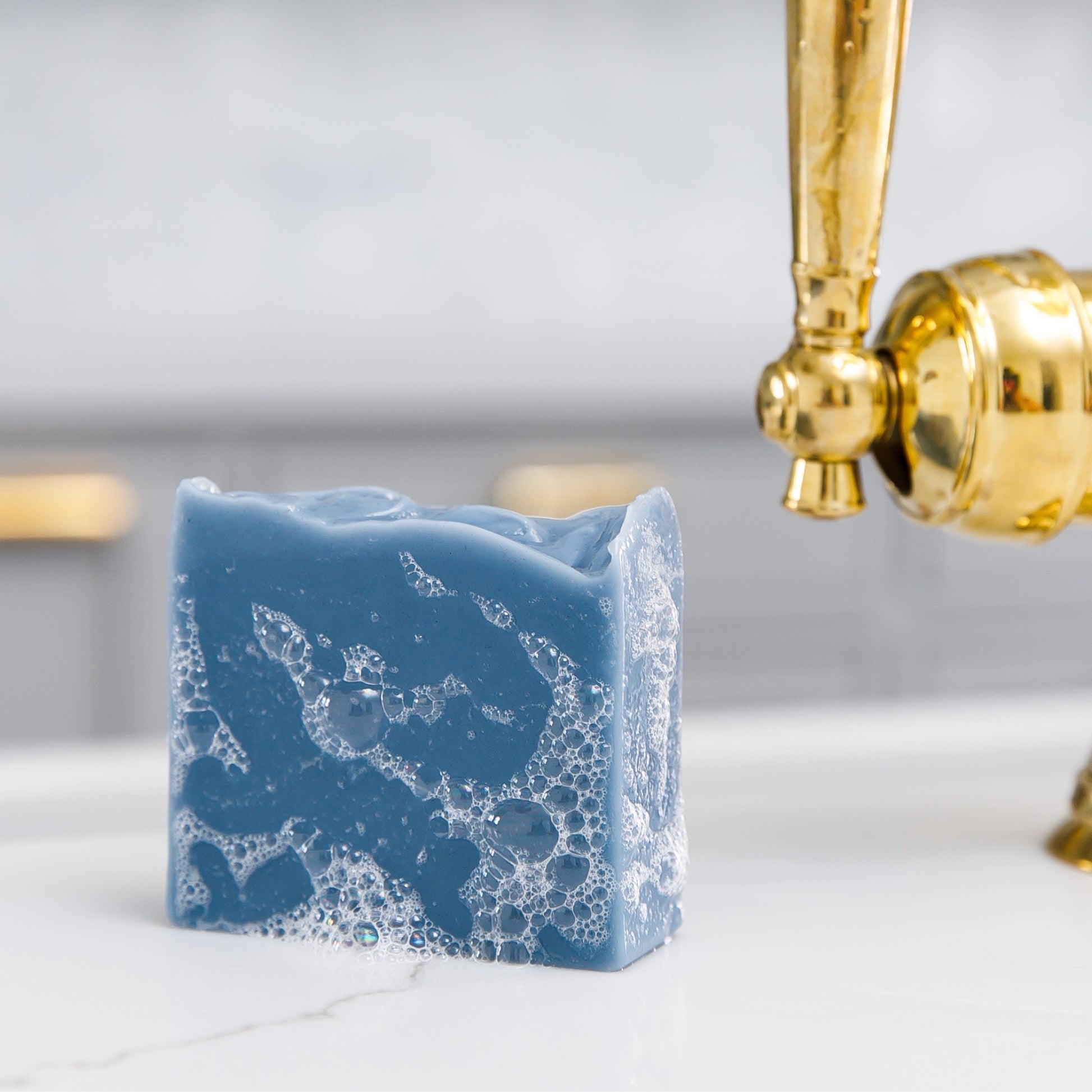 Sudsy Oceanswept Bar Soap sits beside sink 