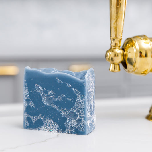 Sudsy Oceanswept Bar Soap sits beside sink 