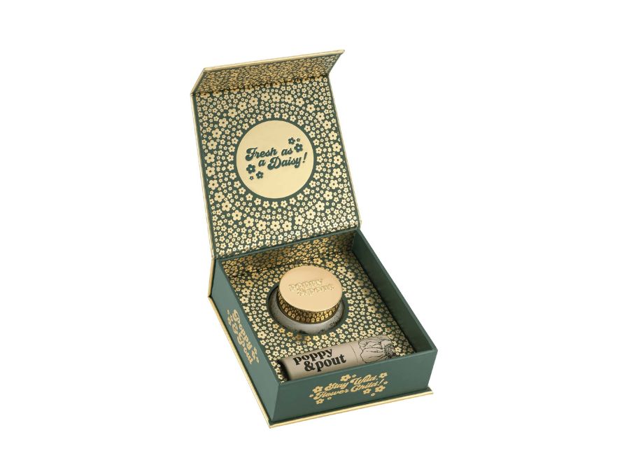 Decorative box with a lid featuring text and a small container inside on a white background