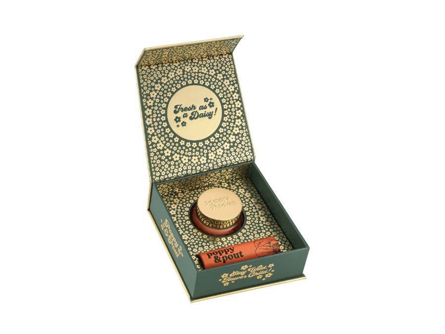 Open gift box with a round item and a cylindrical item inside, on a white background