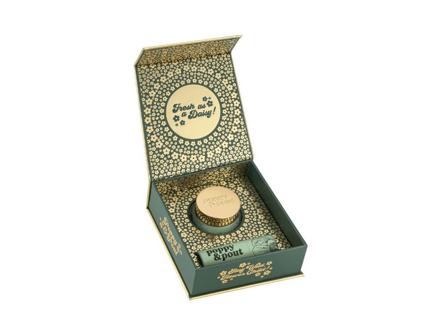 Open box with a small bottle and packaging on a white background