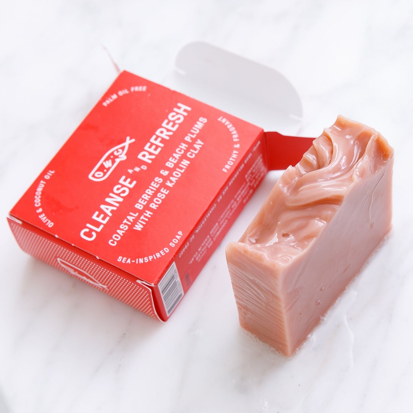 Seaberry & Rose Clay Bar Soap sitting beside open packaging 