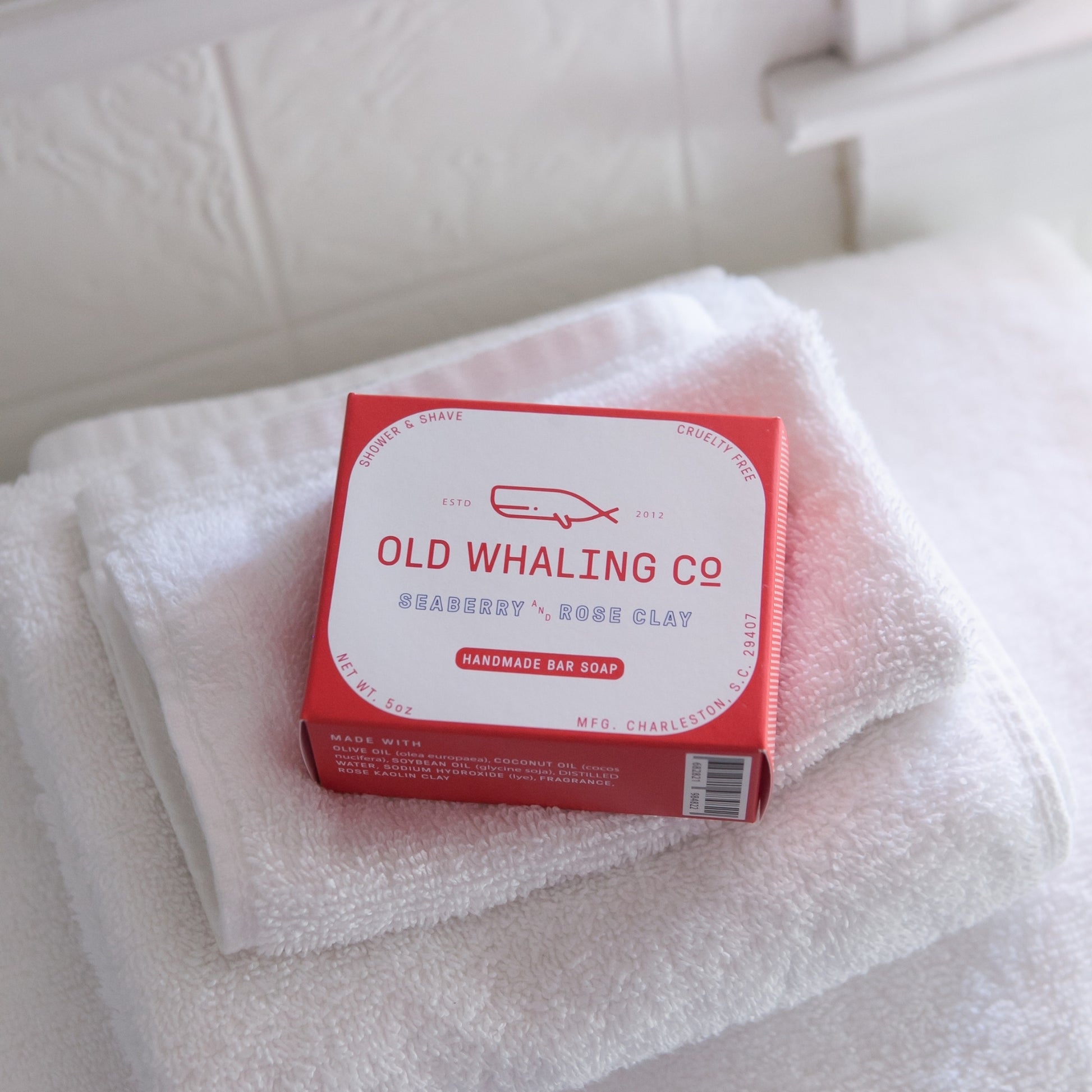 Seaberry & Rose Clay Bar Soap box sits on top of stack of white towels