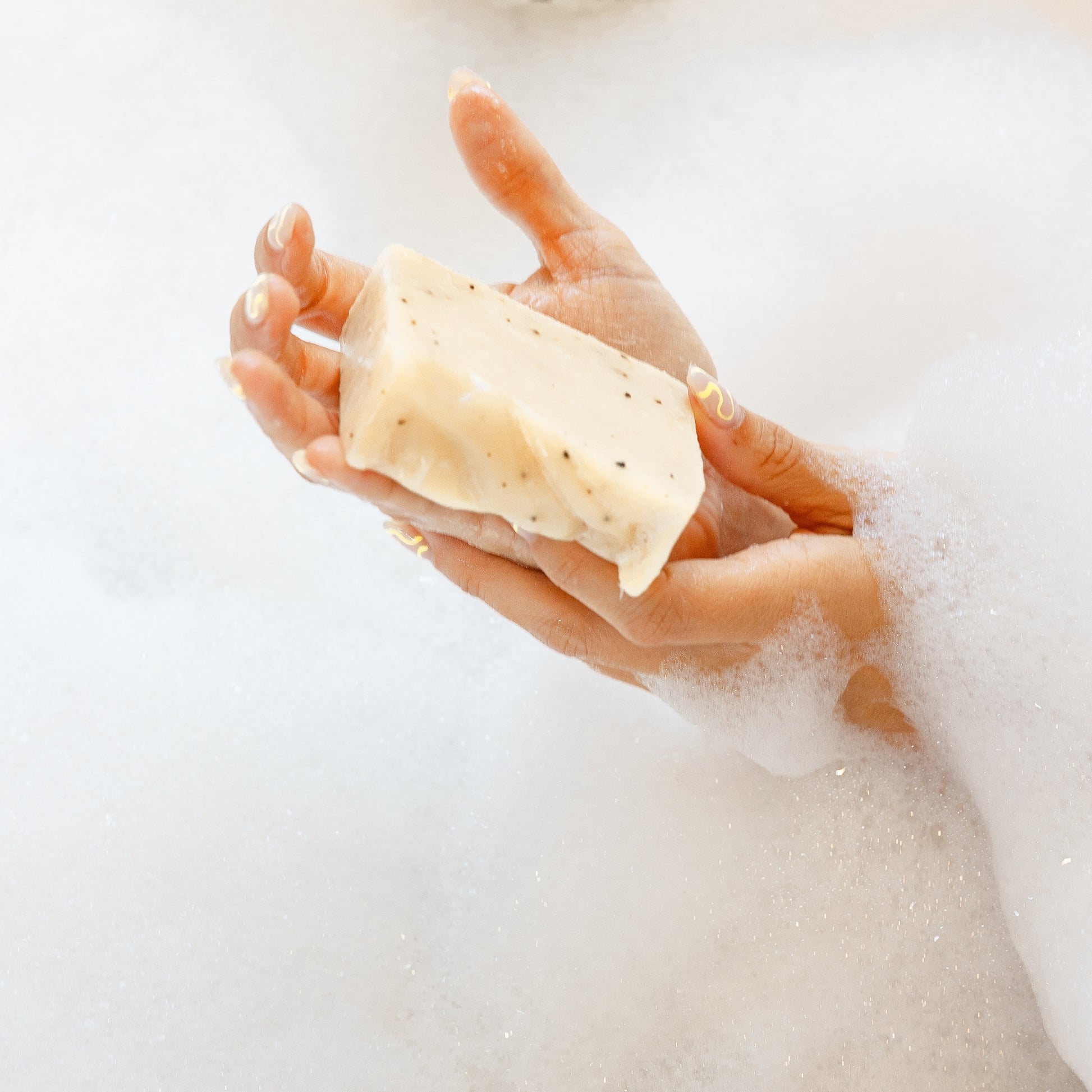 Hands using Seaweed & Sea Salt Bar Soap in a bubble bath