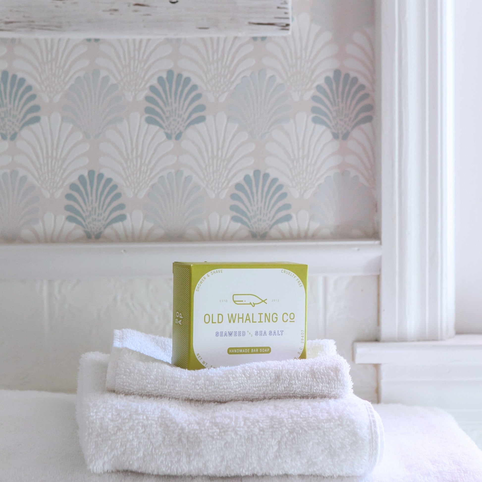 Seaweed & Sea Salt Bar Soap box sitting on stack of white towels 