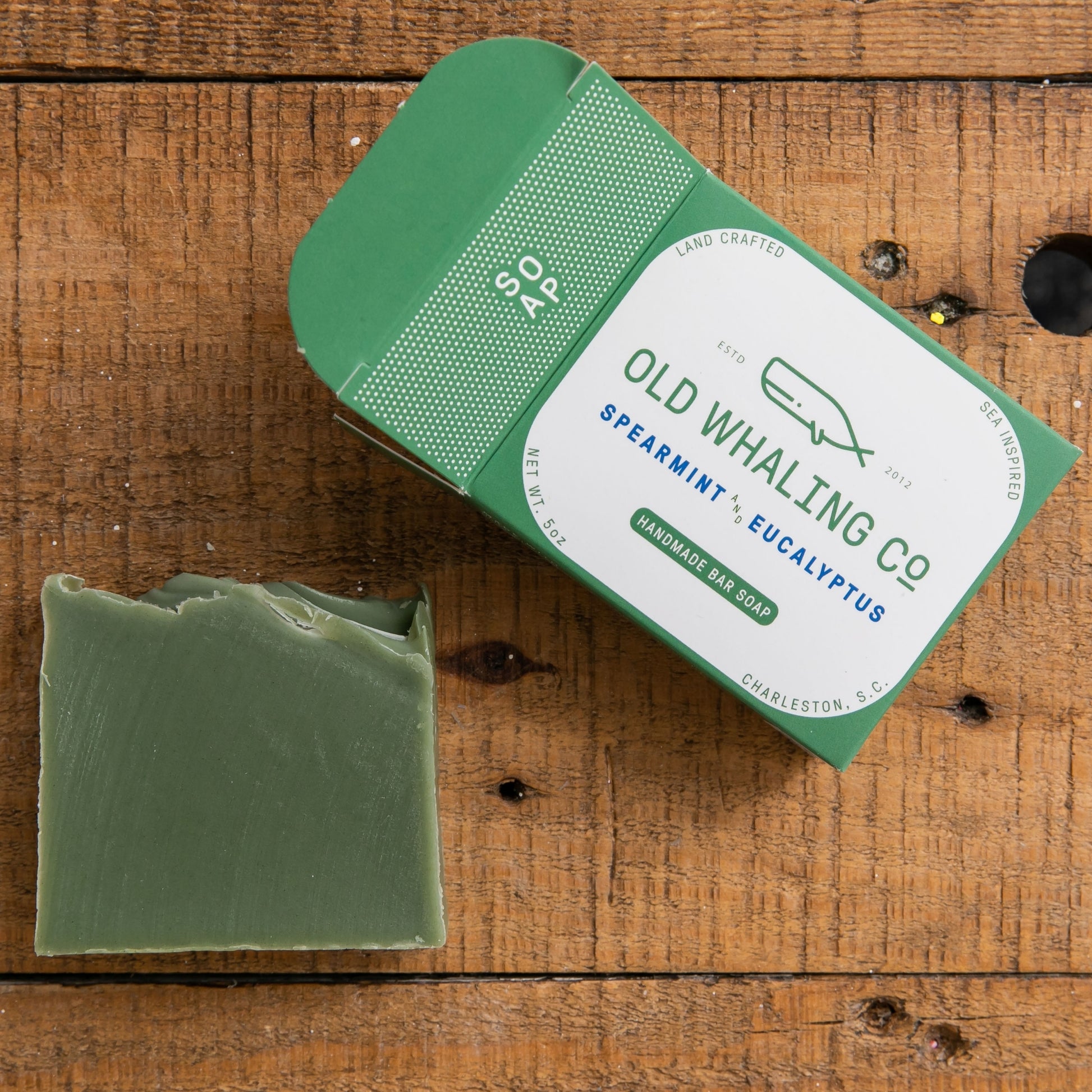 Spearmint & Eucalyptus Bar Soap box and unboxes Bar Soap lay on wood table