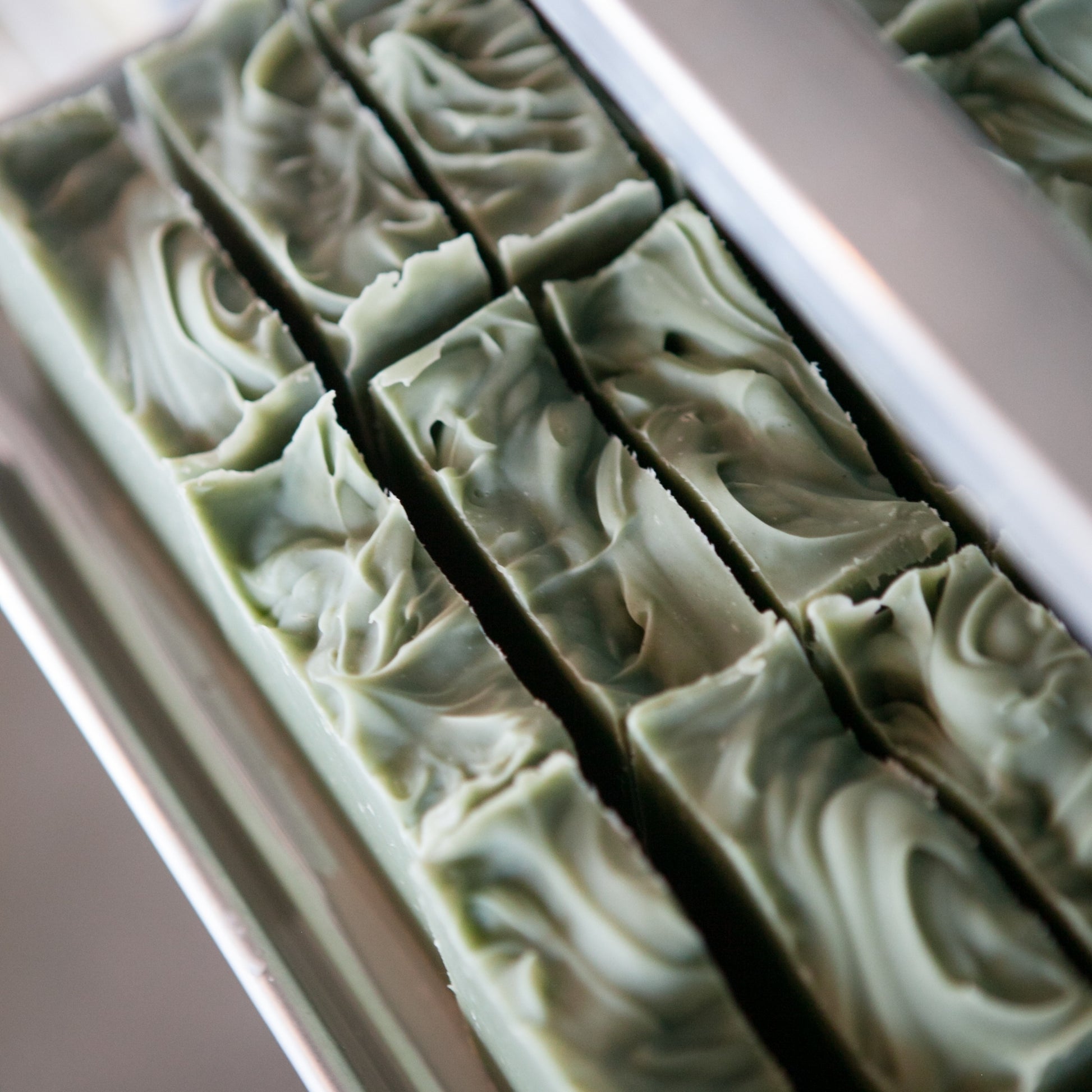 Top view of freshly cut, unboxes Spearmint & Eucalyptus Bar Soaps on standing on soap tray