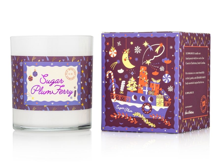 Candle with decorative label and matching box on a white background