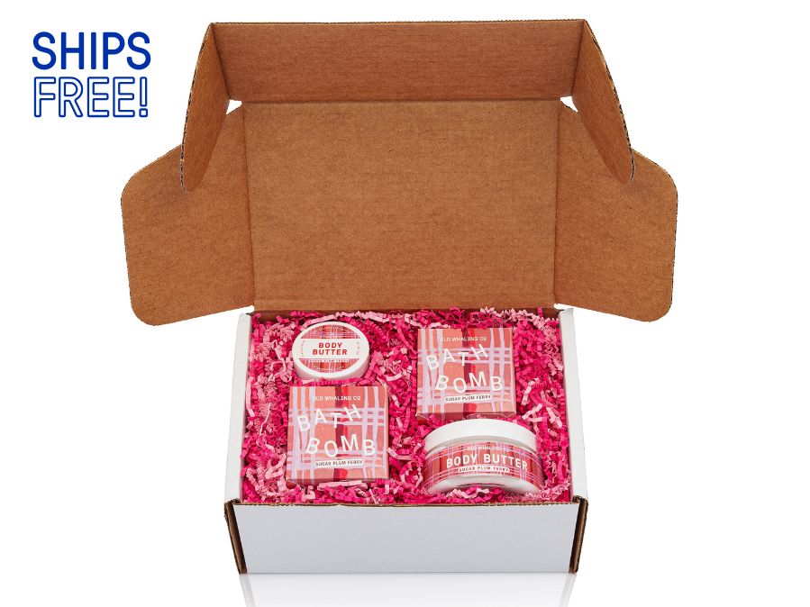 Sugar Plum Ferry gift box with pink and red crinkle in a white box on a white background with ships free note