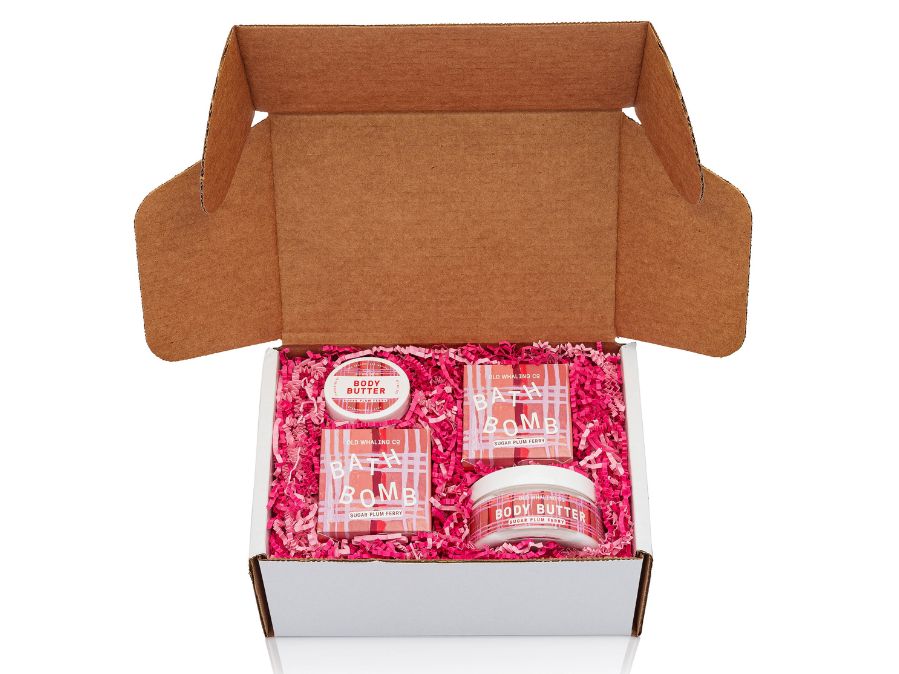 Sugar Plum Ferry gift box with pink and red crinkle in a white box on a white background