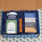 The Dad Gift Box complete with Old Whaling Company products sitting on a table cloth with green floral patterns