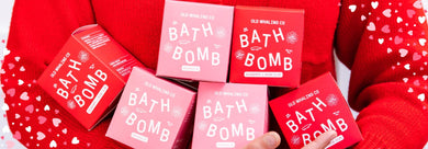 OWC Employee holding Magnolia and Seaberry bath bombs in both arms