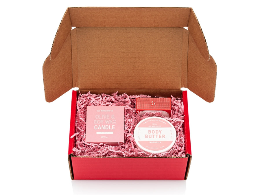 Valentines gift box in a red box with pink crinkle with Magnolia candle and body butter plus Seaberry soap