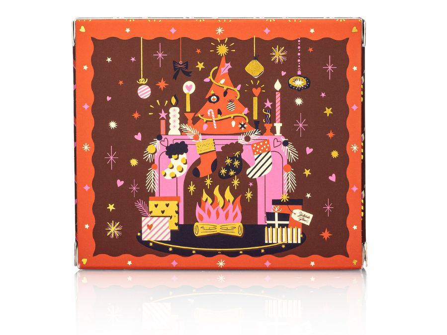 Decorative bar soap box with festive design featuring a fireplace, stockings, and presents on a white background.