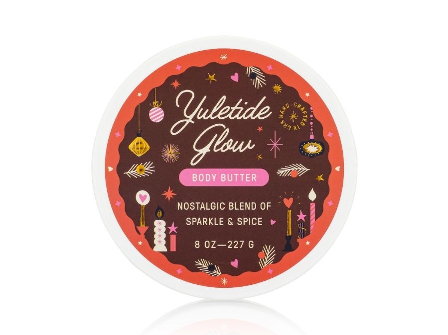 Yuletide Glow body butter container with decorative label on a white background
