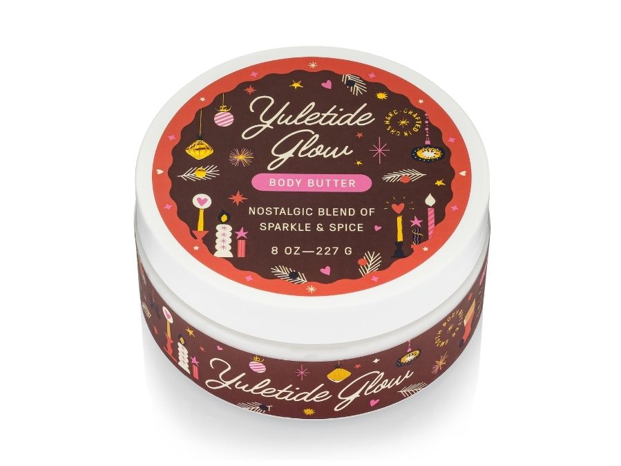 Yuletide Glow body butter container with festive label on a white background