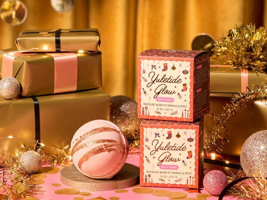 Yuletide Glow product packaging with Christmas decorations on a festive background