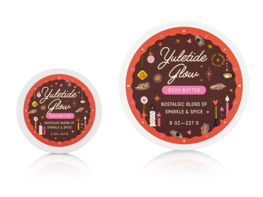 Two containers of 'Yuletide Glow' body butter with festive labels on a white background.