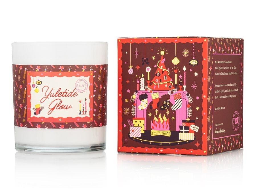 Candle with decorative label and matching box on a white background